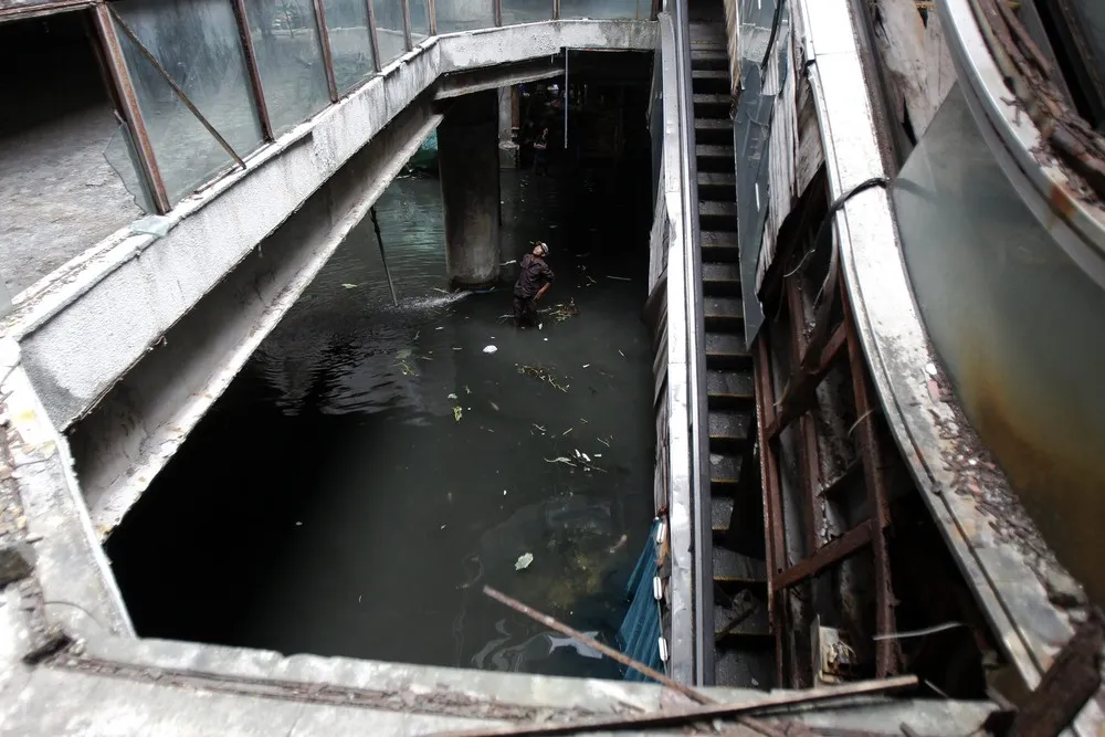 Fishing in the Flooded Ground Floor of an Abandoned Department Store in Bangkok