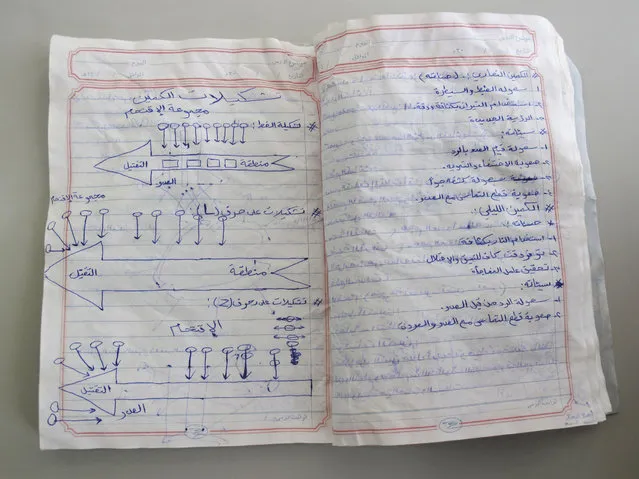 A notebook belonging to an al Qaeda fighter, which was found in a former militant training camp in southern Yemen in May 2014, is seen in this picture taken July 8, 2014. The left page shows diagrams depicting various types of ambushes. (Photo by Martin Dokoupil/Reuters)