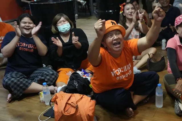 Supporters of Move Forward party cheer as they watch the counting of votes on television at Move Forward Party headquarters in Bangkok, Thailand, Sunday, May 14, 2023. Vote counting was underway Sunday in Thailand's general election, touted as a pivotal chance for change nine years after incumbent Prime Minister Prayuth Chan-ocha first came to power in a 2014 coup. (Photo by Sakchai Lalit/AP Photo)