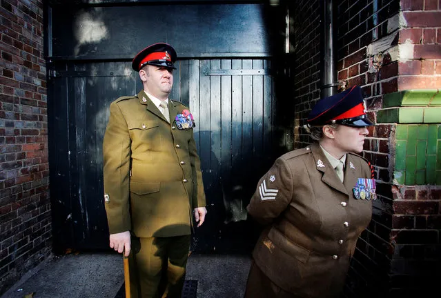 Military personnel watch a Remembrance Sunday parade through Fulham in West London, Britain November 13, 2011. (Photo by Kevin Coombs/Reuters)