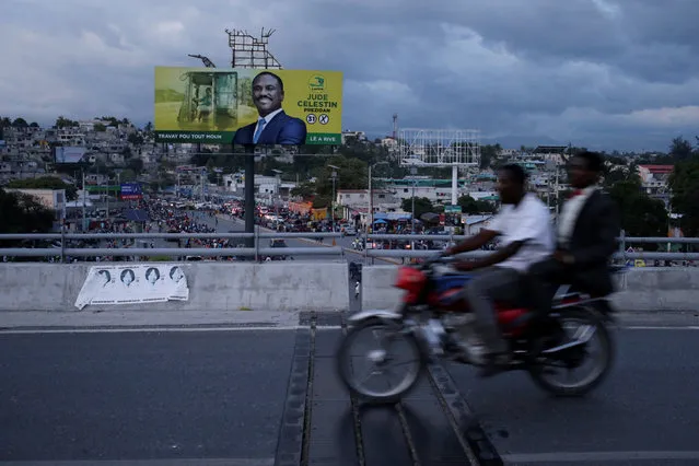 Men riding a motorbike pass an electoral billboard of presidential candidate Jude Celestin of LAPEH (Alternative League for Progress and Emancipation of Haiti) party, ahead of the presidential election, in a street of Port-au-Prince, Haiti, November 17, 2016. (Photo by Andres Martinez Casares/Reuters)