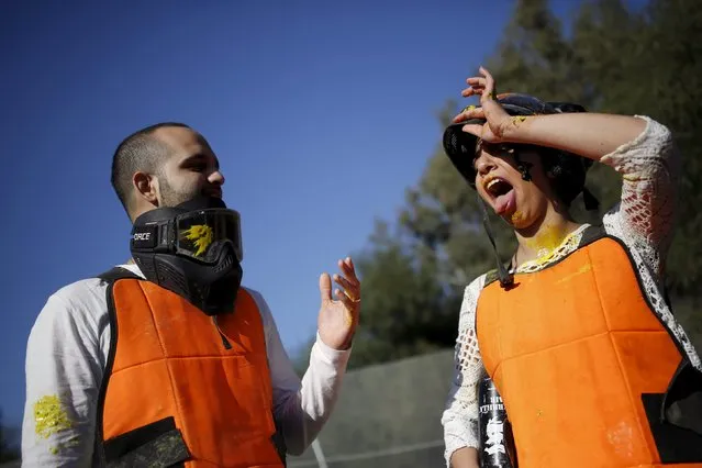 An Israeli couple attend a “trash the dress” event at a paint-ball venue in the southern Israeli city of Ashdod, December 25, 2015. (Photo by Amir Cohen/Reuters)