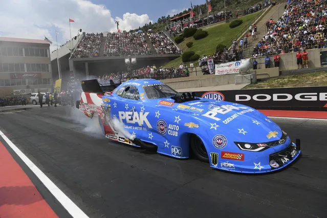 In this photo provided by the NHRA, John Force drives to the Funny Car victory at the annual Dodge Mile-High NHRA Nationals at Bandimere Speedway in Denver, Sunday, July 22, 2018. (Photo by Jerry Foss/NHRA via AP Photo)