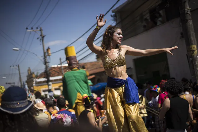 A reveler dances on stilts during the “Ceu na Terra”, or Heaven on earth, carnival parade in Rio de Janeiro, Brazil, Saturday, February 7, 2015. (Photo by Felipe Dana/AP Photo)