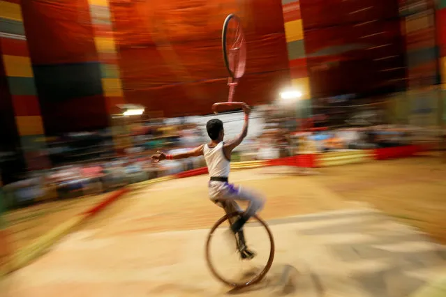 A member of Sakura circus team performs during the second day of a one week show in Padukka, near Colombo, Sri Lanka November 28, 2016. (Photo by Dinuka Liyanawatte/Reuters)