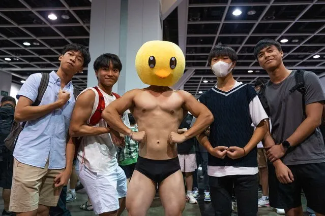 People pose with a dressed cosplayer during the annual Animation-Comic-Game in Hong Kong on July 30, 2023. (Photo by Bertha Wang/AFP Photo)