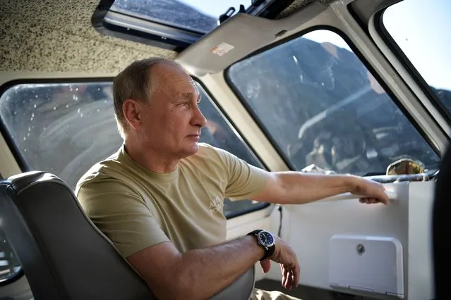 A photo made available on 27 August 2018 shows Russian President Vladimir Putin sitting in a vehicle during his visit in the Tuva region in Siberia, Russia, 26 August 2018. (Photo by Alexei Nikolsky/EPA/EFE/Sputnik/Kremlin/Pool)