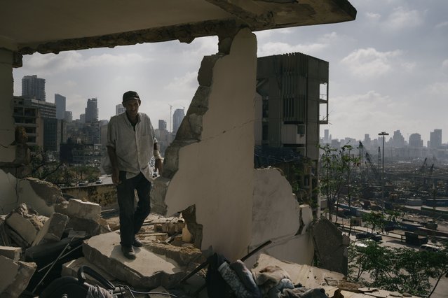 In this image released by World Press Photo, Thursday April 15, 2021, by Lorenzo Tugnoli, Contrasto, for The Washington Post, part of a series titled Port Explosion in Beirut, which won first prize in the Spot News Stories category, shows Abdullah Dalloul walks in the ruins of his former home on August 14, 2020, which was destroyed by the blast in the port of Beirut, Lebanon. Following the explosion, he and his family squatted in the damaged building with no water or electricity. (Photo by Lorenzo Tugnoli, Contrasto, for The Washington Post, World Press Photo via AP Photo)