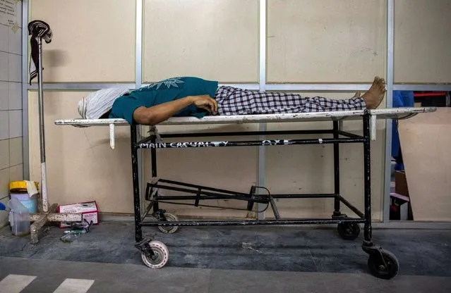 Body of man who died from the coronavirus disease (COVID-19) is seen at the casualty ward in Lok Nayak Jai Prakash (LNJP) hospital, amidst the spread of the disease in New Delhi, India April 15, 2021. (Photo by Danish Siddiqui/Reuters)