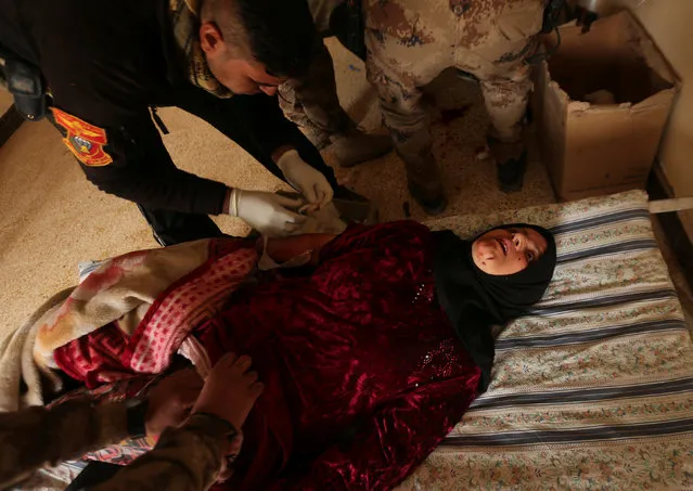 An Iraqi woman, who was wounded during clashes in the Islamic State stronghold of Mosul, lies on a bed at a field hospital in al-Samah neighborhood, Iraq December 1, 2016. (Photo by Mohammed Salem/Reuters)