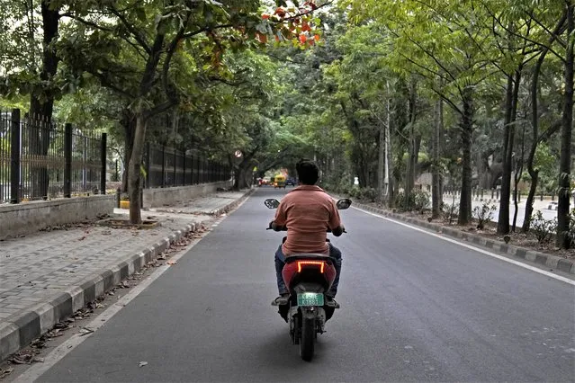A man rides an electric scooter through a street in Bengaluru, India, Monday, August 28, 2023. India is one of the fastest growing electric vehicle markets in the world. (Photo by Aijaz Rahi/AP Photo)