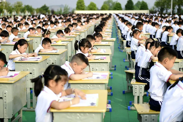 Students compete in a calligraphy contest in a primary school in Anlong county in southwest China's Guizhou province Friday, April 23, 2021. (Photo credit should read Feature China/Barcroft Media via Getty Images)