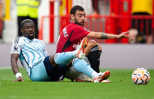 Nottingham Forest's Serge Aurier (L) in action with Manchester United's Bruno Fernandes (R) during the English Premier League soccer match between Manchester Unitedand Nottingham Forrest, in Manchester, Britain, 26 August 2023. (Photo by Peter Powell/EPA)