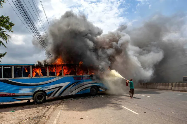 Bangladesh Nationalist Party (BNP) activists set a bus on fire as they block a highway in Dhaka on July 29, 2023, while they protest asking for Prime Minister Sheikh Hasina's resignation. The opposition Bangladesh Nationalist Party (BNP) and its allies have staged a series of protests since 2022 demanding Sheikh Hasina to step down and allow a caretaker government to oversee elections due January 2024. (Photo by AFP Photo/Stringer)