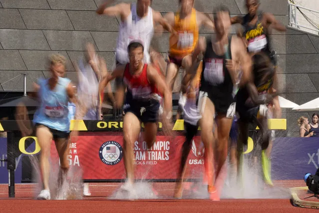 Runners compete during first heat of the men's 3000-meter steeplechase at the U.S. Olympic Track and Field Trials Monday, June 21, 2021, in Eugene, Ore. (Photo by Charlie Riedel/AP Photo)