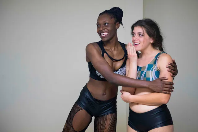 Professional wrestler Gia Scott (L) hugs her opponent and friend professional wrestler Aria Palmer (R) backstage after being told their match was very well choreographed during Autumn Armageddon 2018 in Galena, Maryland on October 6, 2018. (Photo by Jim Watson/AFP Photo)