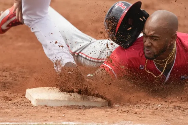 Panama's Edgar Munoz slides safely to first after batting during a baseball game against Mexico at the Pan American Games in Santiago, Chile, Monday, October 23, 2023. Panama won 8-2. (Photo by Moises Castillo/AP Photo)