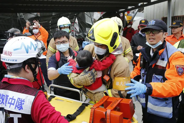 A baby boy is rescued from a collapsed building after an earthquake in Tainan, Taiwan, Saturday, February 6, 2016. (Photo by Wally Santana/AP Photo)