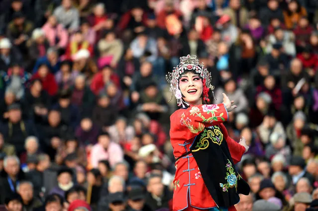 An actress wearing a traditional costume sings an opera during the Spring Festival celebrations in Bozhou, Anhui province, China February 11, 2016. (Photo by Reuters/Stringer)