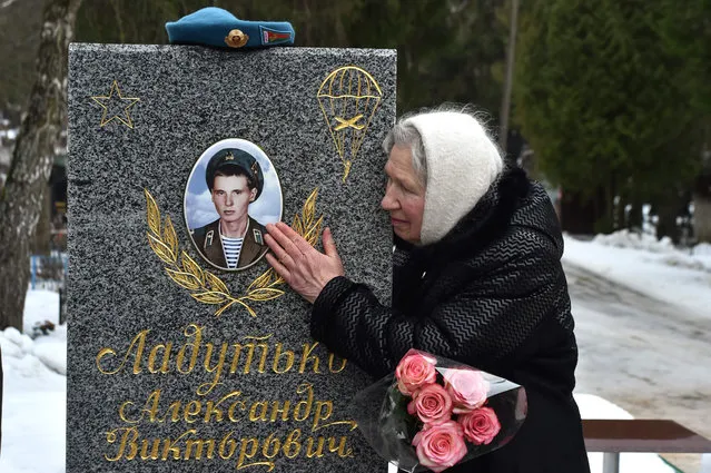 Larisa Ladutko, 78, visits a grave of her son Alexander, killed in 1984 during the Soviet War in Afghanistan on the 30th anniversary of the Soviet troops withdrawal at Chizhovskoe cemetery, outside Minsk on February 15, 2019. (Photo by Sergei Gapon/AFP Photo)