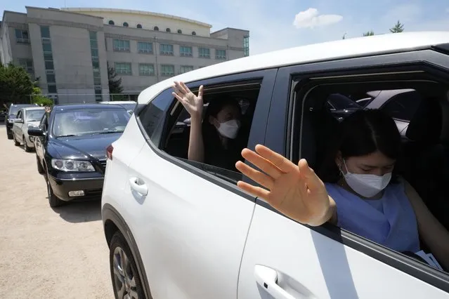 Christians inside their car pray during a drive-in worship service amid measures to help prevent the spread of the coronavirus at the Songgok high school in Seoul, South Korea, Sunday, July 25, 2021. (Photo by Ahn Young-joon/AP Photo)