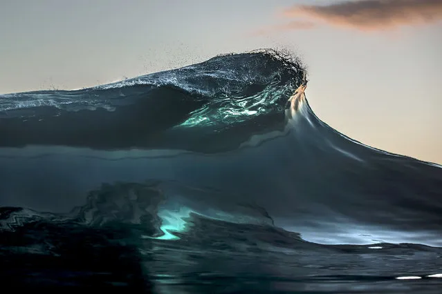 A shot of a wave crashing down into the ocean in the clear waters of Teahupoo. (Photo by Ben Thouard/Caters News)