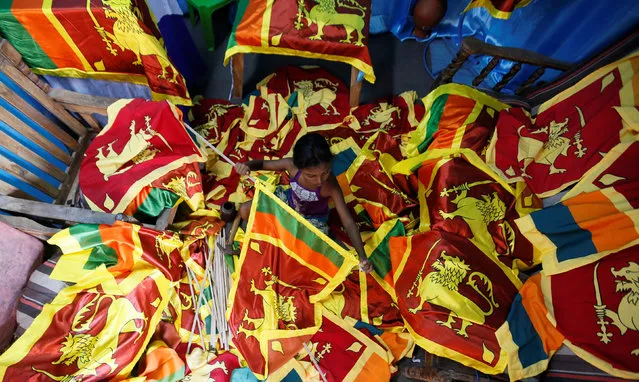 A girl fixes national flags at a workshop, ahead of celebrations of Sri Lanka's 69th Independence Day in Colombo, Sri Lanka,  February 1, 2017. (Photo by Dinuka Liyanawatte/Reuters)