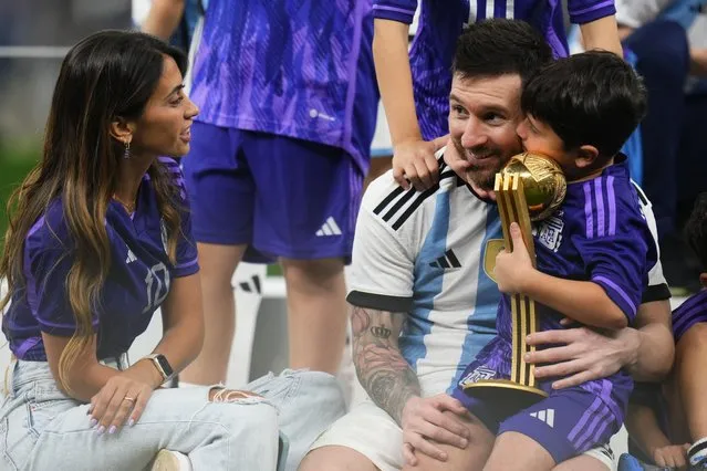 Argentina's Lionel Messi celebrates with his family after winning the World Cup final soccer match between Argentina and France at the Lusail Stadium in Lusail, Qatar, Sunday, December18, 2022. (Photo by Manu Fernandez/AP Photo)
