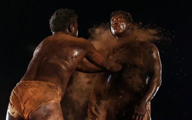 Wrestlers apply mud to prevent slipping during an Indian traditional wrestling competition also known as Kushti at a wrestling arena popularly known as Akhara during a local competition event in Mumbai, India, 20 March 2016 (issued 21 March). Kushti is a traditional Indian form of wrestling which usually takes place in a clay or dirt pit also known as Akhara. These traditional and ancient form of sport is slowly losing its shine to modern wrestling but a few dedicated people try to continue to train themselves and keep this culture alive. (Photo Divyakant Solanki/EPA)