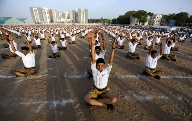 Volunteers of the Hindu nationalist organisation Rashtriya Swayamsevak Sangh (RSS) exercise as they take part in an annual celebration in Ahmedabad, India, April 10, 2016. (Photo by Amit Dave/Reuters)