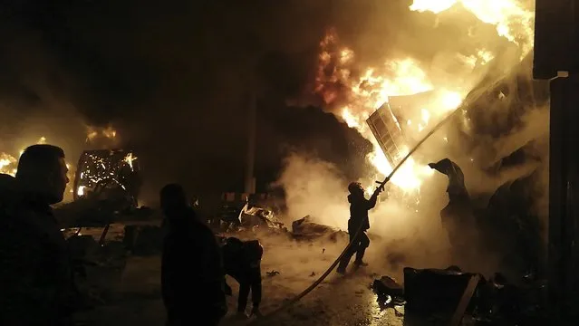 In this photo released by the Syrian official news agency SANA, firefighters work at the scene of missiles attack, at the seaport of the coastal city of Latakia, Syria, Tuesday, December 28, 2021. Israeli missiles fired from the Mediterranean struck the Syrian port of Latakia early Tuesday, igniting a fire in the container terminal, Syrian state media reported, in the second such attack on the vital facility this month. (Photo by SANA via AP Photo)