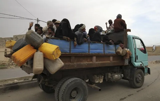 Internally displaced people ride on the back of a truck as they flee in the district of Khamir of Yemen's northwestern province of Amran May 9, 2015. (Photo by Mohamed al-Sayaghi/Reuters)