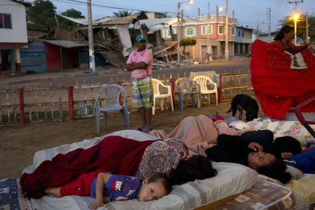 Residents wake from their slumber, outside their collapsed homes damaged by a 7.8-magnitude earthquake, in Manta, Ecuador, Wednesday, April 20, 2016. (Photo by Rodrigo Abd/AP Photo)
