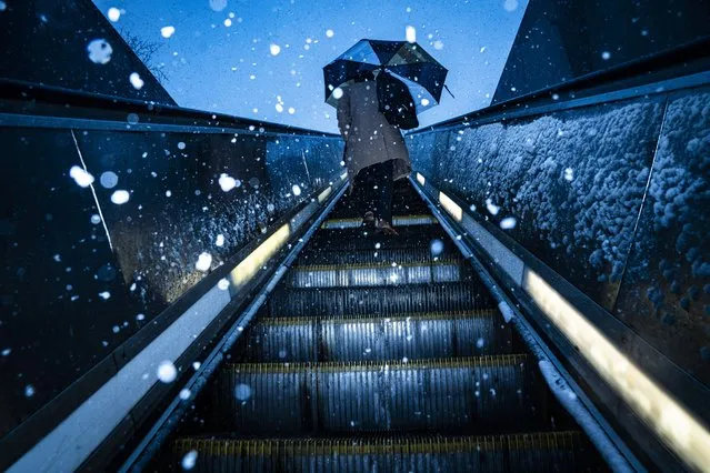Patrons exit the metro as snow falls after a winter storm warning was issued on Capitol Hill on Monday, Jan. 03, 2022 in Washington, DC. (Photo by Jabin Botsford/The Washington Post)