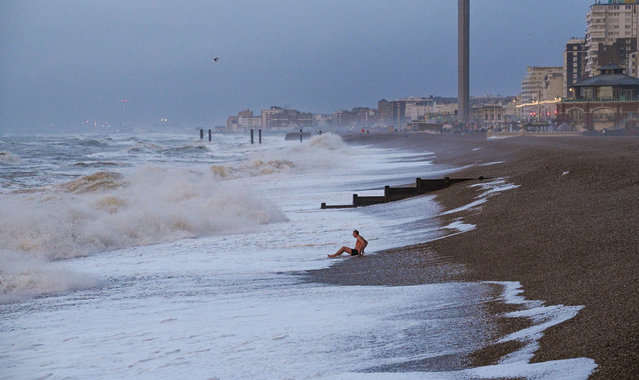 A swimmer bathes in the surf, a practice known as pilcharding, on the city’s beach in Brighton, England in the second decade of January 2024. (Photo by Simon Dack News/Alamy Live News)