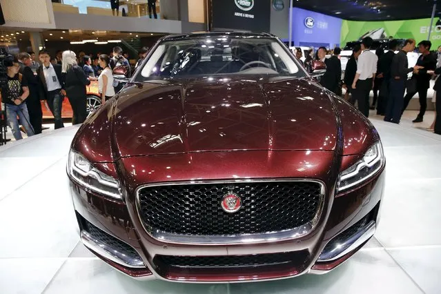 People gather around newly unveiled Jaguar XFL during the Auto China 2016 auto show in Beijing April 25, 2016. (Photo by Damir Sagolj/Reuters)