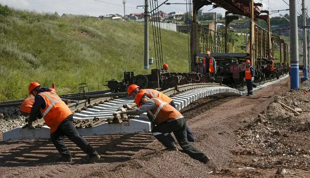 A services brigade of the Russian Railways replaces rail tracks of the Trans-Siberian Railway outside the Siberian city of Krasnoyarsk, Russia, July 13, 2015. (Photo by Ilya Naymushin/Reuters)