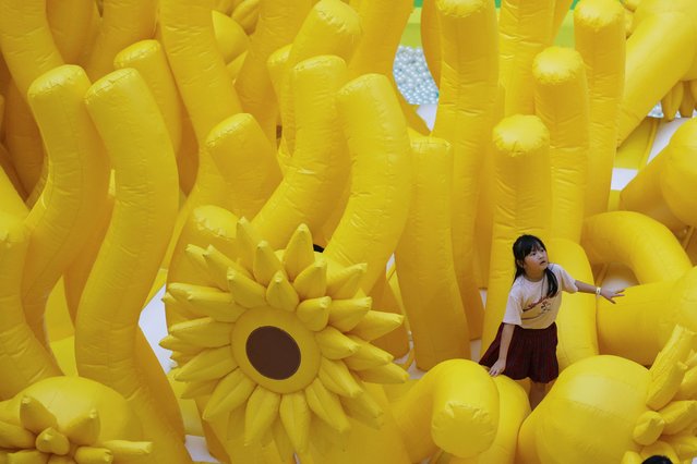 A girl plays on a giant inflatable at a shopping mall in Jakarta, Indonesia, on June 20, 2024. (Photo by Ajeng Dinar Ulfiana/Reuters)