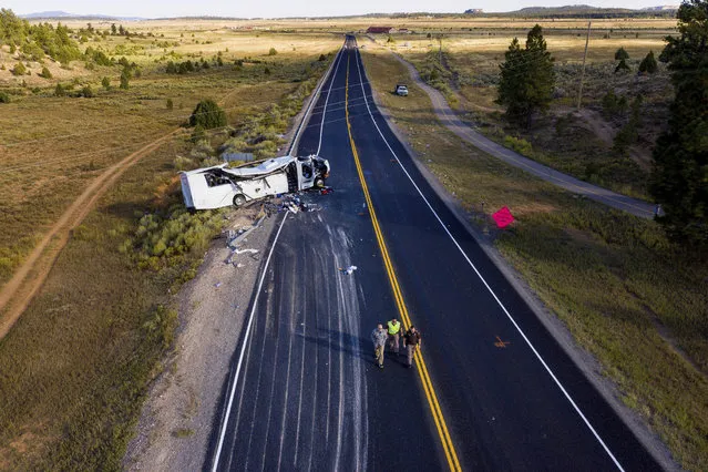 The remains of a bus that crashed while carrying Chinese-speaking tourists lie along State Route 12 near Bryce Canyon National Park, Friday, September 20, 2019, in Utah, as authorities continue to investigate. (Photo by Spenser Heaps/The Deseret News via AP Photo)