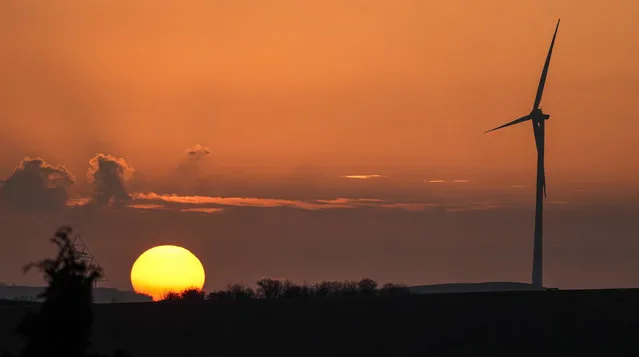 A wind turbine at sunset in Gelsenkirchen, Germany, Monday, January 10, 2022. (Photo by Martin Meissner/AP Photo)