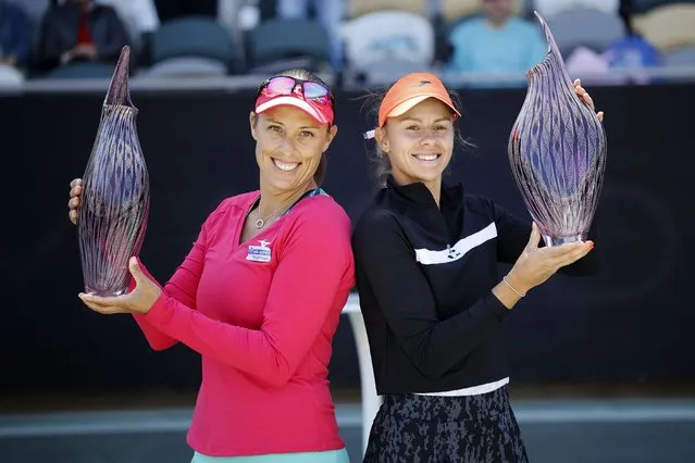 Andreja Klepac, left, and Magda Linette hold up their trophies after winning the doubles title against Lucie Hradecka and Sania Mirza in finals action at the Charleston Open tennis tournament in Charleston, S.C., Sunday, April 10, 2022. (Photo by Mic Smith/AP Photo)