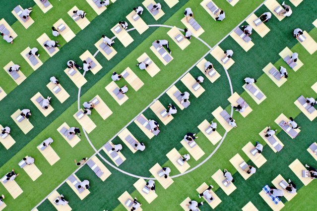 Students take part in a quilt-folding competition during a military-style training on the sports field of a senior high school in Dongyang, in China's eastern Zhejiang province on August 15, 2024. (Photo by AFP Photo/China Stringer Network)