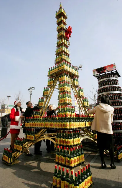 South Korea: A miniature replica of the Eiffel Tower, made of whisky bottles, during a donation drive to help needy neighbours in Seoul December 14, 2004. The 5.3 metre tower consists of 597 bottles. (Photo by Kim Kyung-Hoon/Reuters)