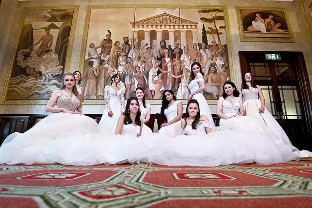 Debutantes attend the Queen Charlotte's Ball 2021 at One Whitehall Place on September 04, 2021 in London, England. Queen Charlotte's Ball is the pinnacle event in the London Season. The young ladies, usually aged between 17 and 20 attend the grand ball, wearing gowns by Mignonette, where they are presented to guests and curtsey to the Queen Charlotte Cake which this year is by Fehmee John at BbBus. King George III introduced the Queen Charlotte's Ball in 1780 to celebrate his wife's birthday and debutantes were traditionally presented to the King or Queen until 1958. (Photo by Kate Green/Getty Images)