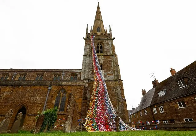 “Flower Tower” a display of more than 4,300 handmade knitted and crocheted flowers is seen at All Saints Church, ahead of Platinum Jubilee celebrations for Britain's Queen Elizabeth, in Middleton Cheney, Britain, May 26, 2022. (Photo by Andrew Boyers/Reuters)