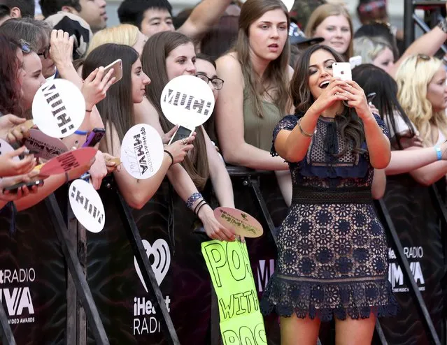 Video blogger Bethany Mota takes a photograph as she arrives for the iHeartRadio Much Music Video Awards (MMVAs) in Toronto, Ontario, Canada June 19, 2016. (Photo by Peter Power/Reuters)
