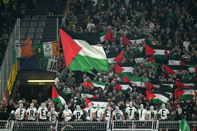 Celtics supporters hold Palestinian flags and stage a protest with the slogan 'Free palestine' during the UEFA Champions League football match between Borussia Dortmund and Celtic in Dortmund, western Germany on October 1, 2024. (Photo by Ina Fassbender/AFP Photo)