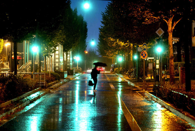 A person crosses a street in the pouring rain in Frankfurt, Germany, early Thursday, September 26, 2024. (Photo by Michael Probst/AP Photo)