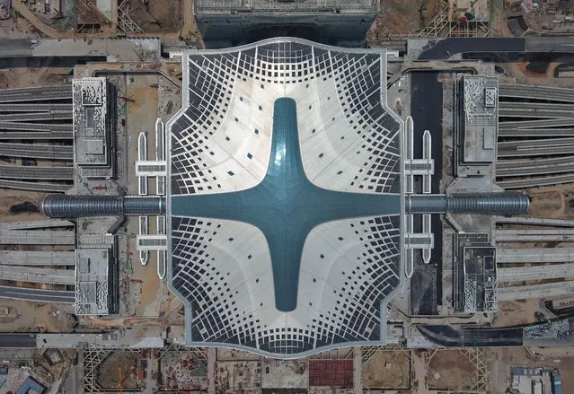 Aerial view of photovoltaic modules on the roof of Hangzhou West Railway Station on August 1, 2022 in Hangzhou, Zhejiang Province of China. As a major traffic hub for the Asian Games Hangzhou 2022, the station has set up 7,540 PV panels for a 15,000-square-meter area, which is expected to generate 2.31 million kilowatt-hours of electricity annually, and reduce carbon dioxide emissions by more than 2,330 tons every year. (Photo by Wang Gang/China News Service via Getty Images)