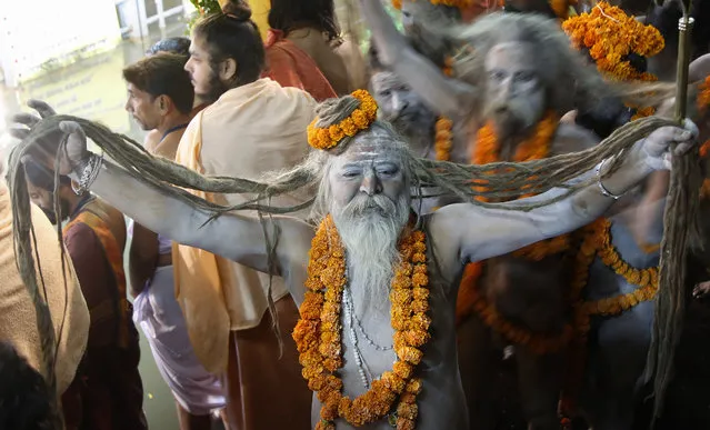 A naked Hindu holy man arrives to bath in the Godavari River during Kumbh Mela, or Pitcher Festival, at Trimbakeshwar in Nasik, India, Saturday, August 29, 2015. (Photo by Rajanish Kakade/AP Photo)